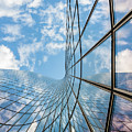 Glass curved building and blue sky